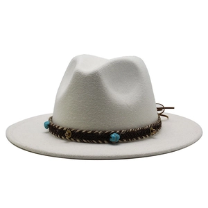 Detailed view of white wool fedora hat with turquoise beads and brown braided band