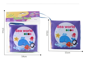 Detail showing sea-themed fabric baby book with whale pattern and product dimensions