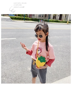 Detailed view of kids strawberry crossbody bag with rhinestones and green leaf decor