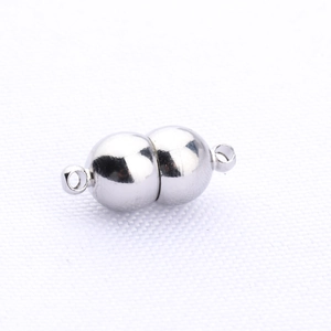 Macro shot of silver plated magnetic clasp connector with dual rings for DIY jewelry making