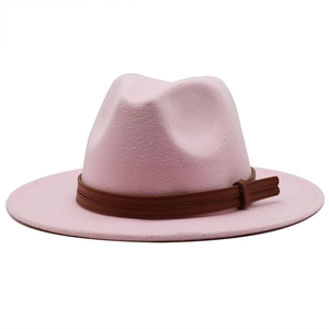 Detail of pink wool fedora hat with a premium dark brown leather decorative band
