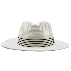 Detailed weave of beige straw fedora hat with classic black and white striped ribbon band