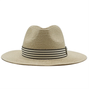 Detailed close-up of natural straw weave and classic striped band on this jazz fedora hat