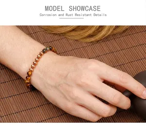 Detail of tiger eye beads and rose gold stainless steel spheres on a female wrist