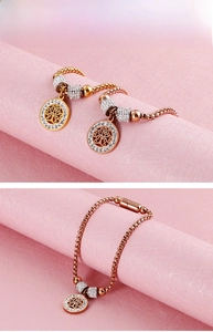 Detail of rose gold tree of life bracelet with white rhinestones on box chain