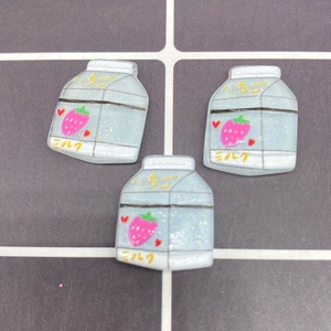 Detail of blue strawberry milk carton resin charms for DIY craft and phone case décor