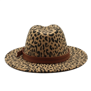 Close-up of leopard print wool fedora hat featuring a brown leather decorative band