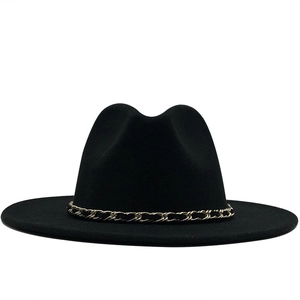 Detail of classic black wool felt fedora with elegant gold and black woven chain