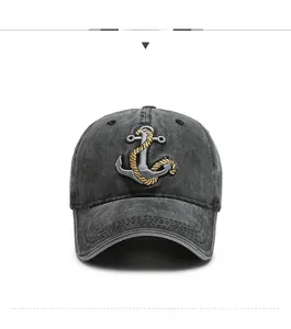Close-up of vintage dark gray washed denim baseball cap with detailed anchor embroidery