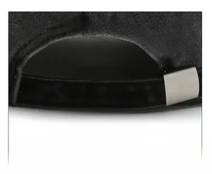 Detailed view of the adjustable metal buckle and washed fabric strap on the baseball cap