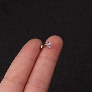 Silver letter A stud earring with cubic zirconia held on a finger for size reference