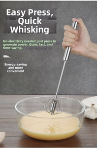 Action shot of stainless steel semi-automatic whisk mixing eggs in a glass bowl