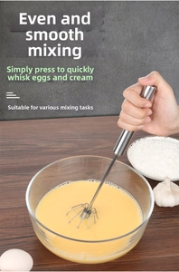 Macro view of semi-automatic stainless steel egg whisk head showing the spiral mixing wire