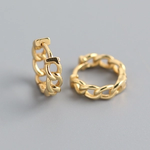 Detailed close-up of golden interlocking chain hoop earrings with a polished finish