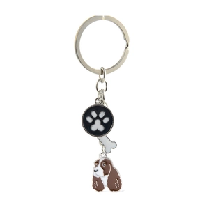 Detail of dog keychain with bone, paw print, and brown Spaniel charm on silver ring