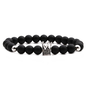 Matte black stone bead bracelet featuring a silver micro-pave crown charm and accents