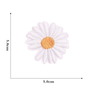 Detailed close-up of a 5.0cm white daisy embroidered patch with yellow center detail