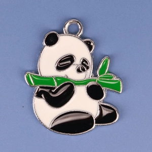 Close-up of DIY panda alloy pendant with green bamboo detail and black and white enamel