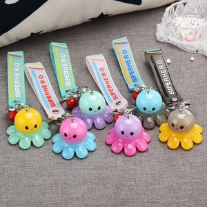 Cartoon octopus keychains with Superhero straps and glowing features in multiple colors