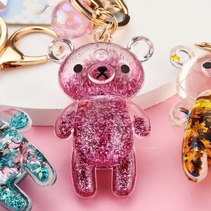 Colorful Rilakkuma quicksand acrylic keychain with glitter and sequins in three vibrant colors