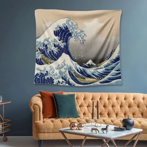Detailed view of The Great Wave off Kanagawa tapestry hanging above a brown leather sofa