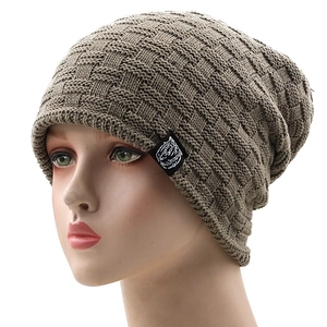 Deep khaki knit beanie with checkered pattern and tiger head patch on a mannequin head