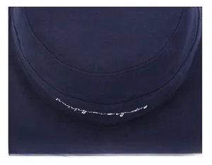 Detailed close-up of dark blue bucket hat crown showing white happy everyday embroidery