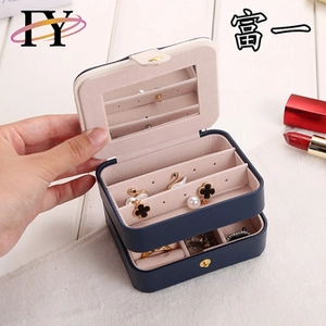 Navy blue velvet jewelry box interior view with built-in mirror and ring storage slots