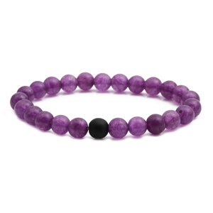 Close-up of purple natural stone beaded bracelet with a single matte black onyx accent