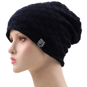 Detail view of dark blue checkered knit beanie featuring a tiger head label on white background