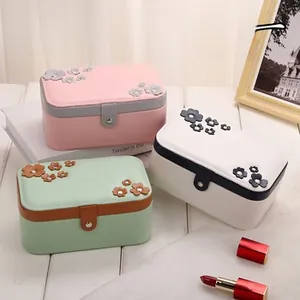 Detail view of mini velvet jewelry boxes with 3D flower lids and metal clasps