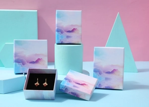 Detailed view of purple cloud jewelry boxes with red gemstone earrings inside