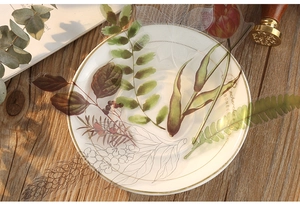 Detailed view of floral PET stickers with green leaves and tulips on a ceramic tray