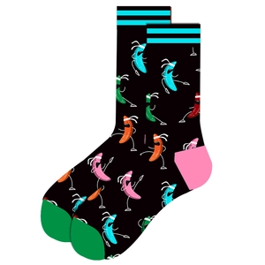 Detail view of cotton socks with colorful cartoon vegetable patterns on black background