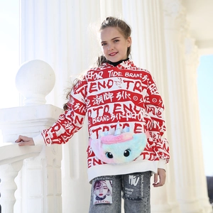 Detailed close-up of a colorful plush unicorn waist bag on a child street style outfit