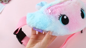 Detail of soft plush unicorn waist bag with colorful faux fur and pink adjustable strap