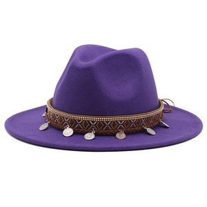 Detail of purple fedora wool hat featuring ethnic woven band and vintage metal coins