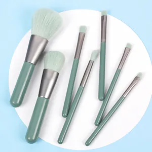 Detailed set of 7 portable makeup brushes with green bristles and matching handles