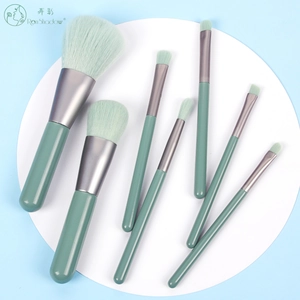 Detailed set of 7 portable makeup brushes with green bristles and matching handles