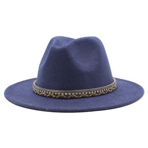 Detailed close-up of a navy blue wool fedora hat with a rhinestone woven band decoration