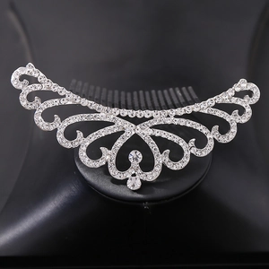 Close-up of sparkling silver bridal crown hair comb with clear rhinestones on black stand
