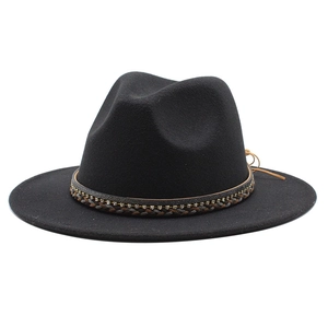 Detail of black wool fedora hat featuring a woven leather band with rhinestone accents