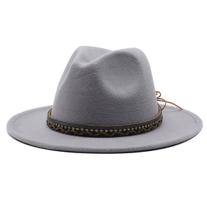 Close-up of light grey wool jazz hat with rhinestone-embedded braided decorative band