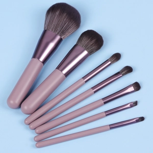 Detail of 7 mini makeup brushes with soft fiber bristles and matte purple handles