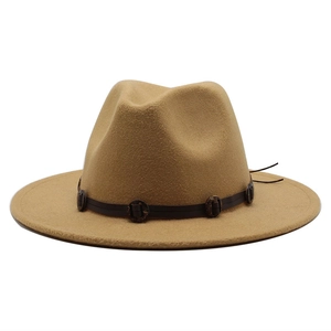Macro detail of camel wool fedora hat with brown leather band and decorative metal studs