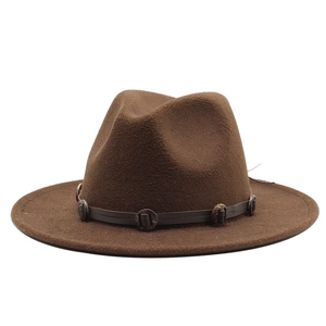 Detail of a brown wool fedora with a vintage leather band and metallic eyelet accents