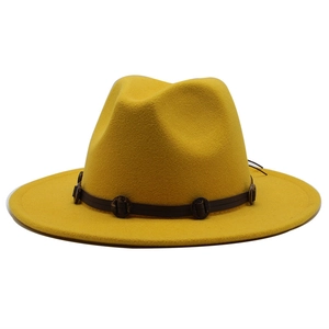 Detail of yellow wool fedora hat featuring wide flat brim and braided belt with wooden beads