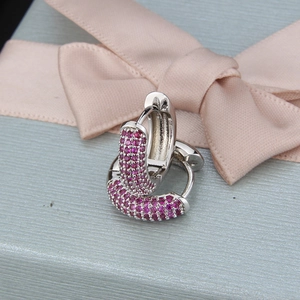 Close-up of pink zircon micro-pave hoop earrings in an elegant jewelry gift box