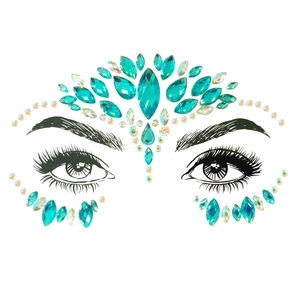 Detailed view of teal and AB crystal face gems applied to forehead and around eyes