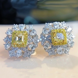 Luxury flower-shaped yellow gemstone stud earrings with sparkling white petal-like diamonds